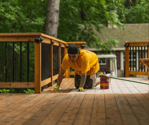 certapro painter staining a deck