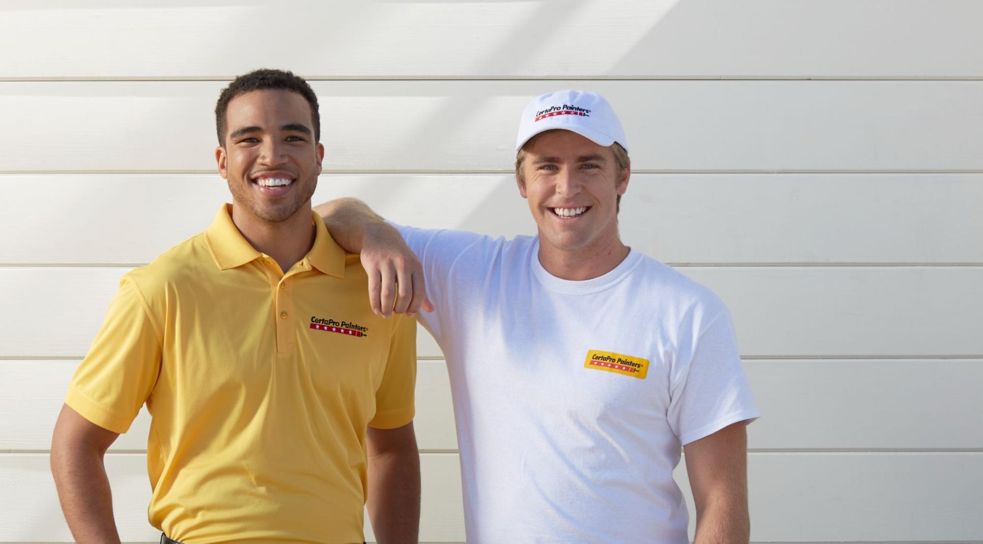 Two men in CertaPro uniforms smiling for a photo