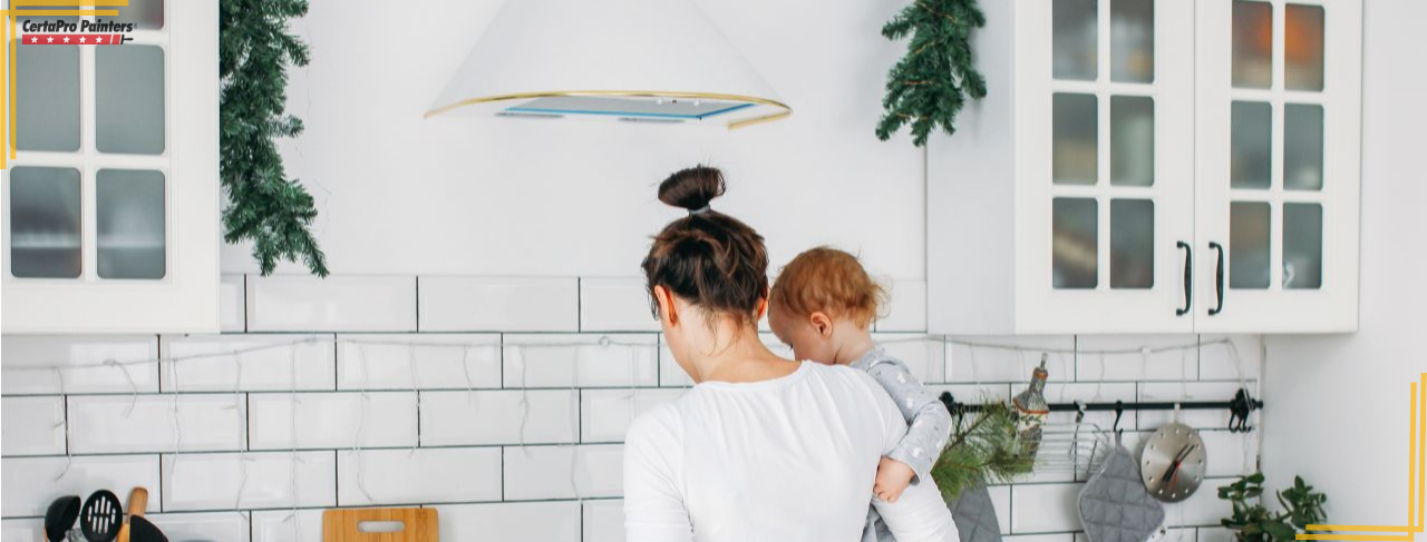 woman holding baby in kitchen