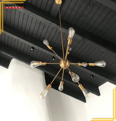 black painted exposed beam ceiling with light fixture