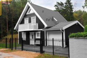 black painted a-frame house with white trim and accents