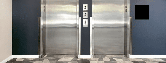 elevators inside an apartment building with blue walls