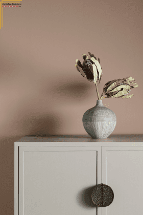 cabinet with vase and dried flowers on top