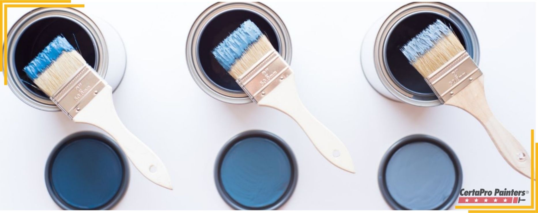 three blue paint cans with three paint brushes