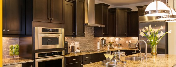 dark brown kitchen cabinets with brass accents