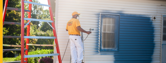 certapro painters team member painting a home exterior