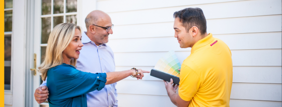 certapro painter with clients choosing exterior painting team member