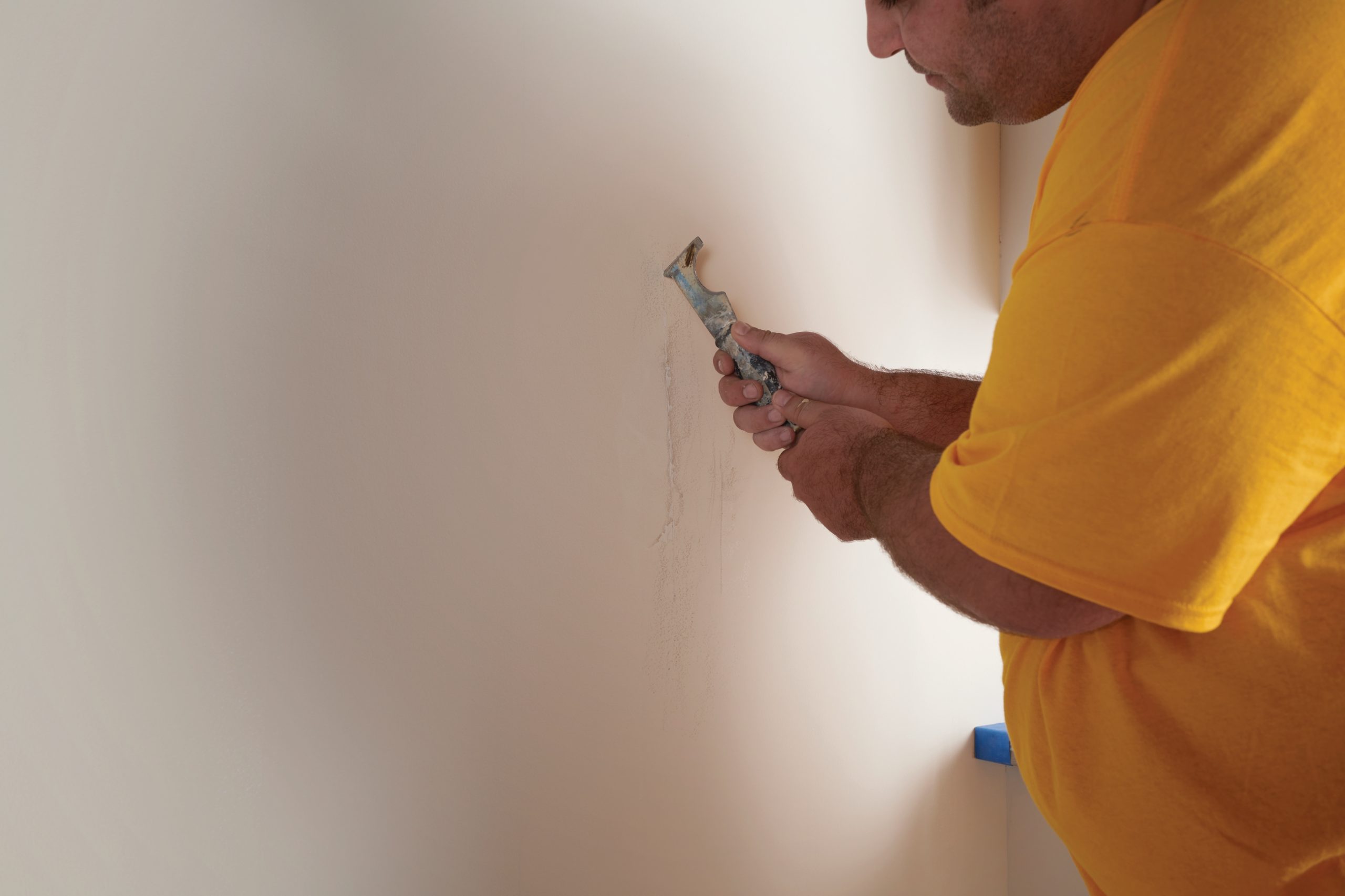painter repairing drywall
