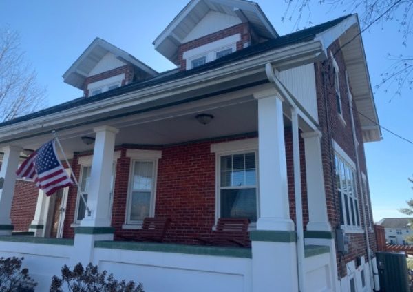 brick house with white front porch and window trim