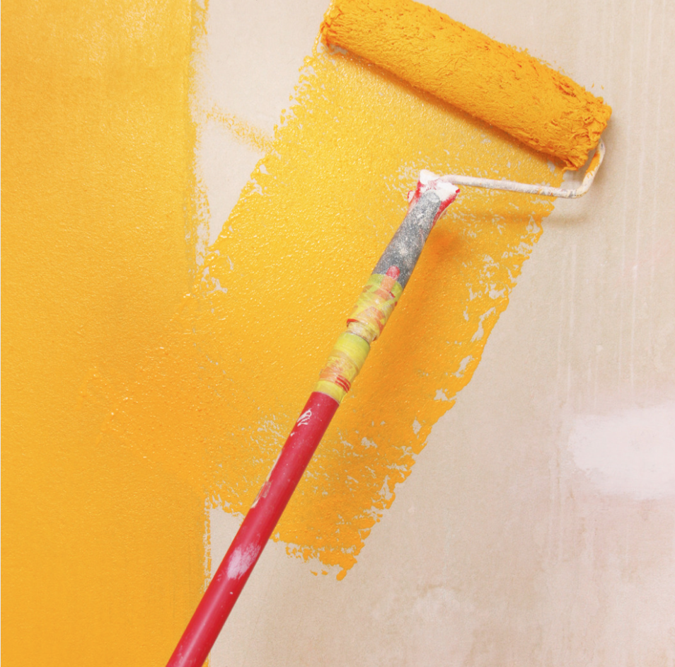 Paint roller painting Gold paint on beige wall