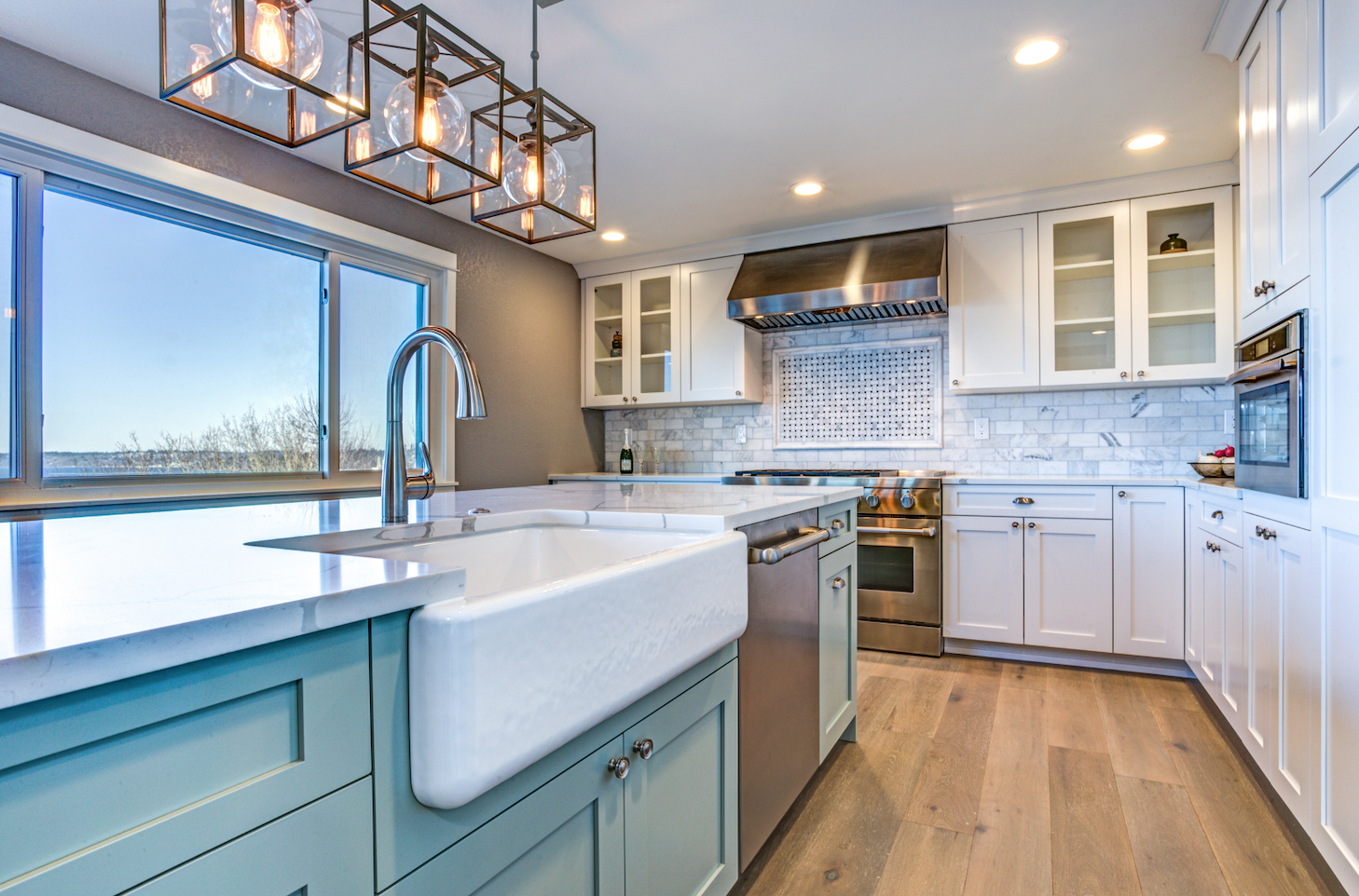 Kitchen with blue and white cabinets with an ocean view