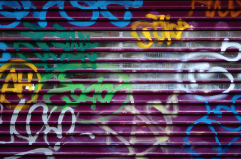 Graffiti painted on metal purple garage door