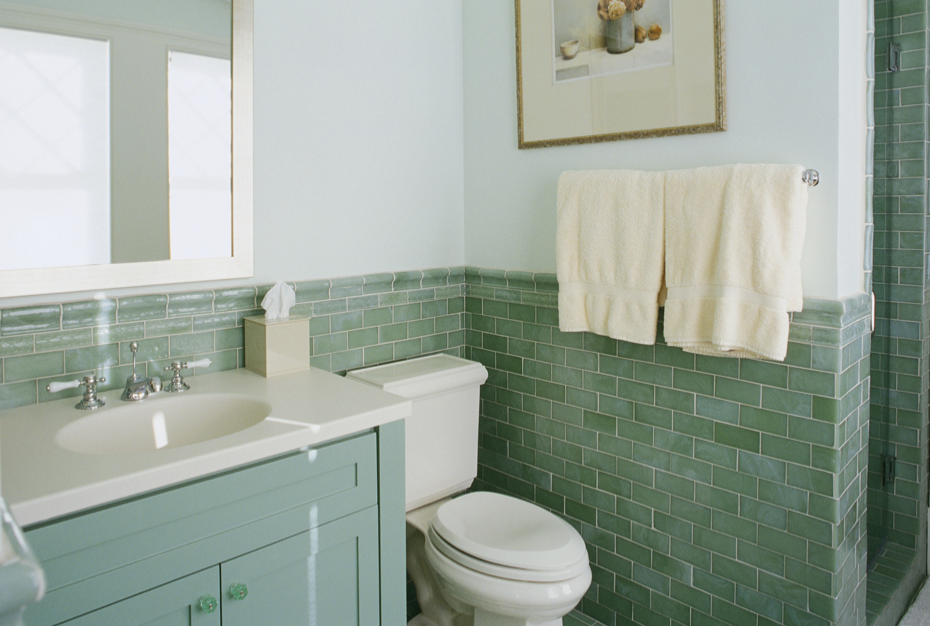 Green vanity with white sink