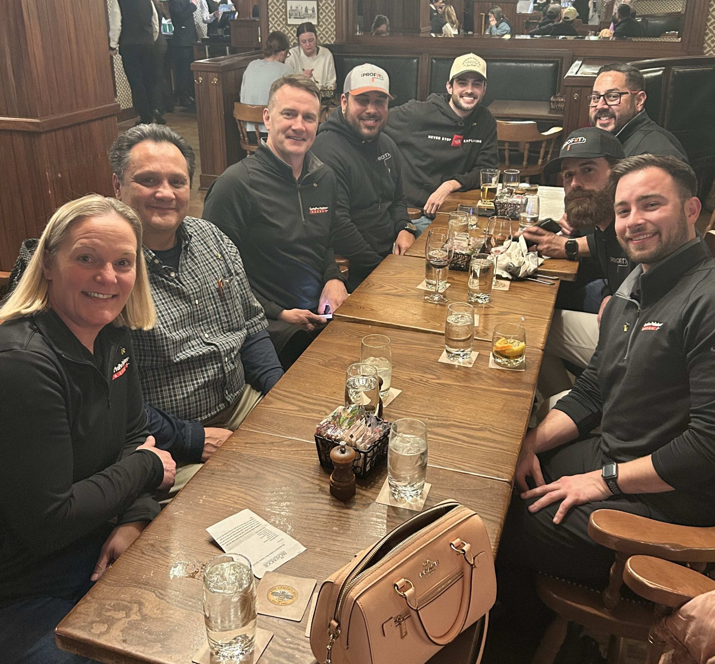 group of people sitting at long restaurant table
