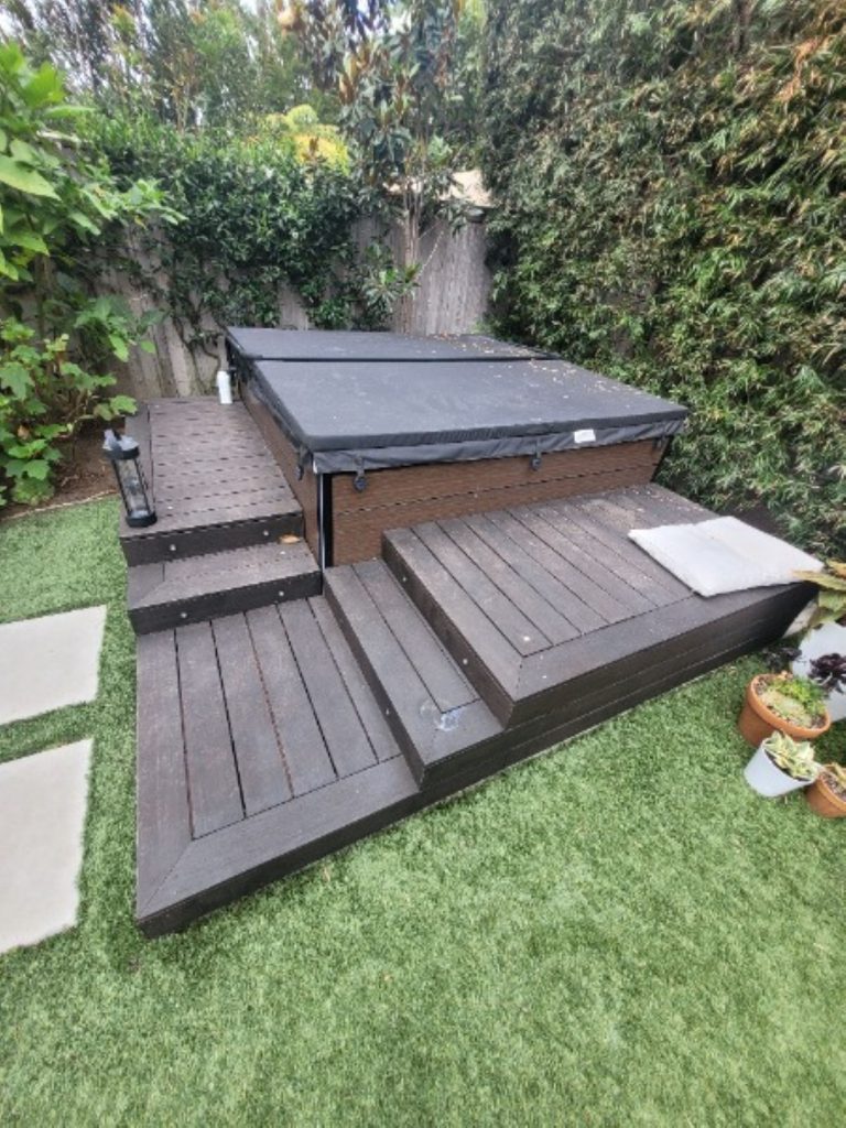 backyard hot tub before deck repaint