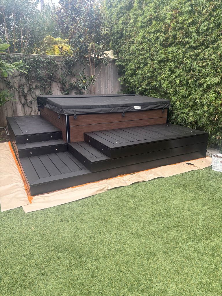 backyard hot tub with painted deck