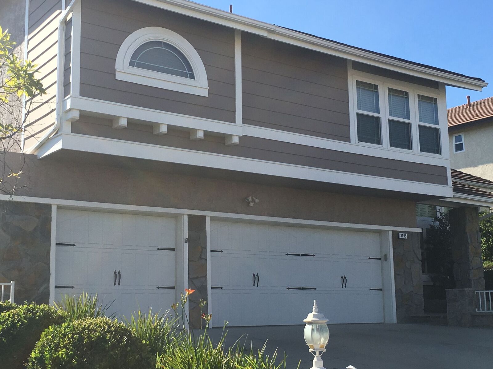 Brown and white siding painted LA