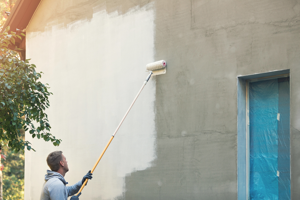 Man Roll Painting Stucco