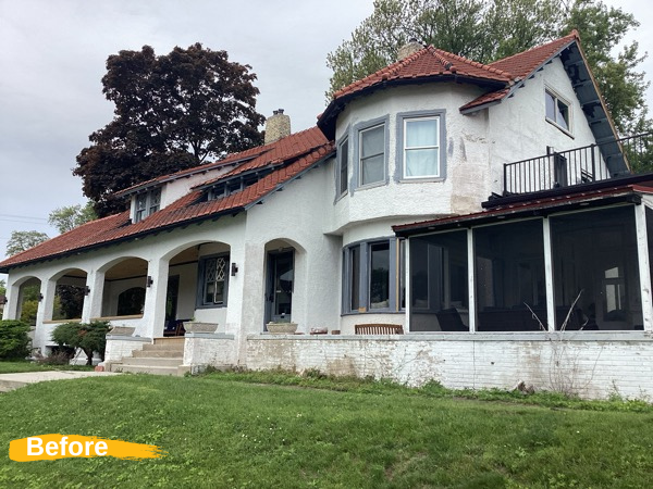 brick and stucco house exterior with paint damage