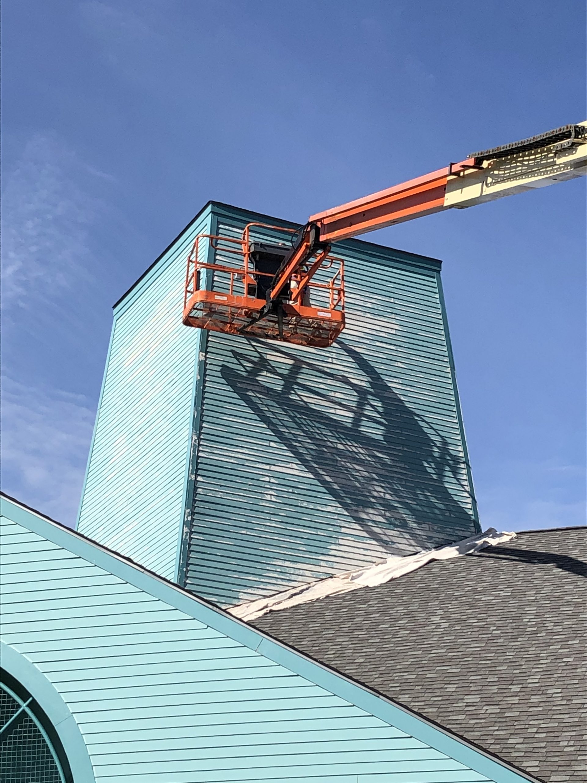 Before photo of paint chipping off tower. 