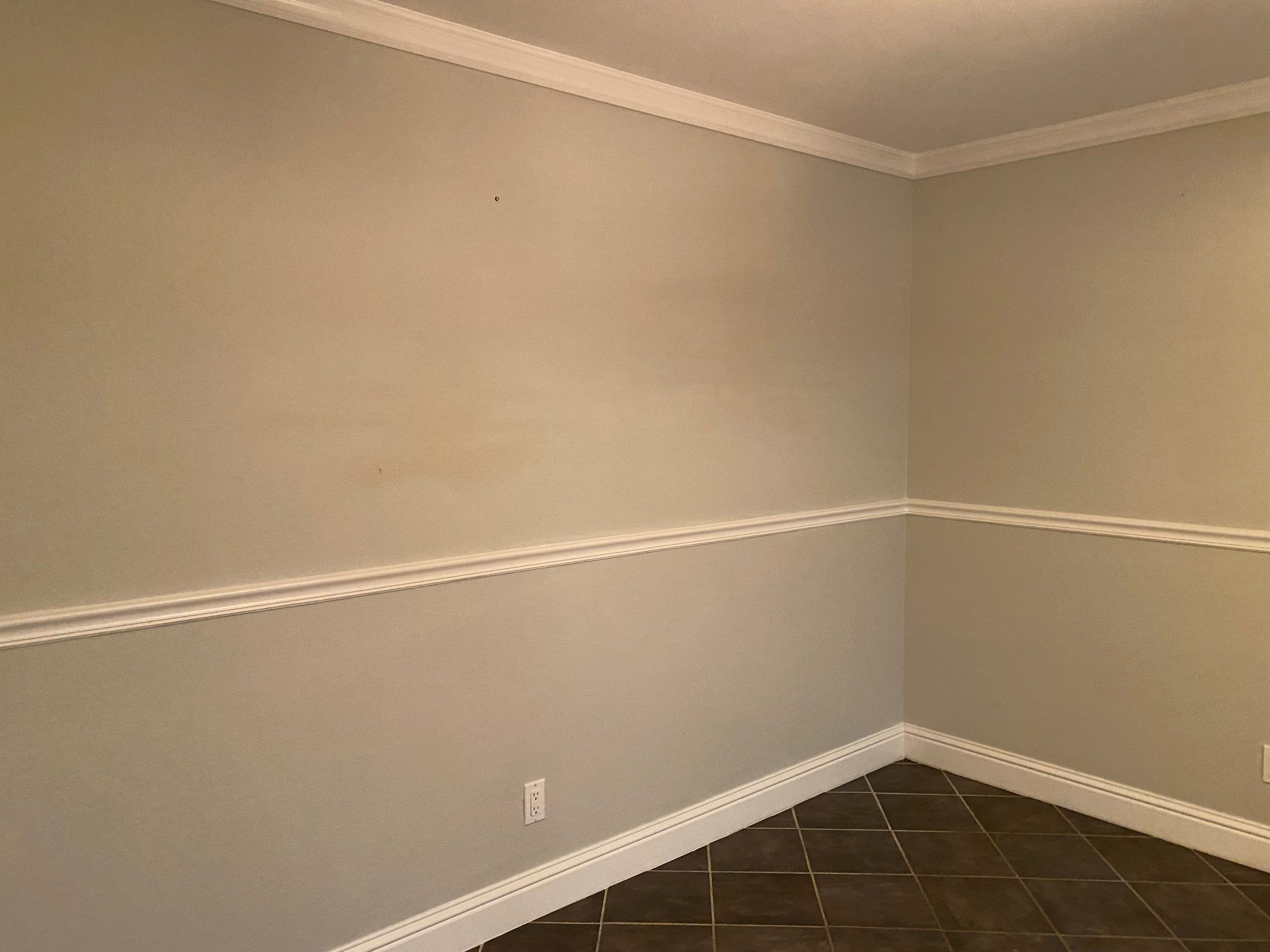 The dining room before being partially repainted with a contrasting color.