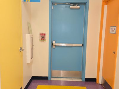 preschool hallway with colorfully painted classroom doors