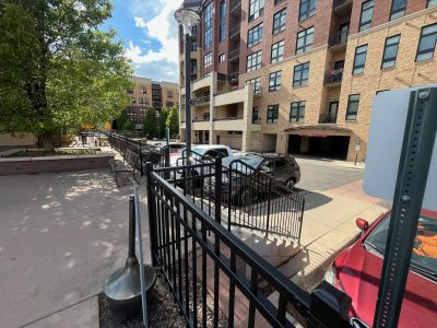 black painted railing along street-facing building exterior