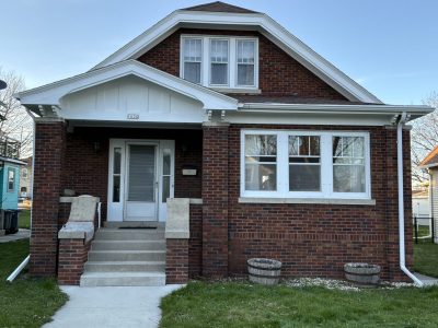 brick home exterior with white painted trim