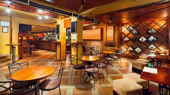 Restaurant with bar, tables, and chairs