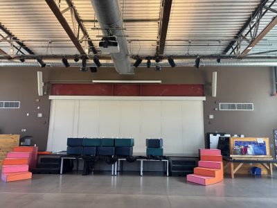 common room of school with stacked blocks and stage equipment