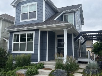 front of house with grey-blue siding and white trim