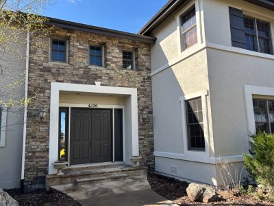 front door and steps of house with painted trim