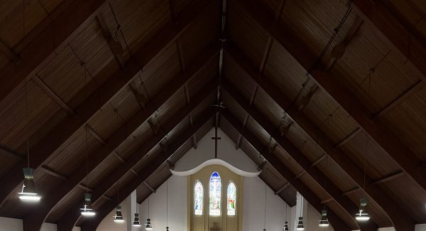 back of church pews and aisle leading to altar