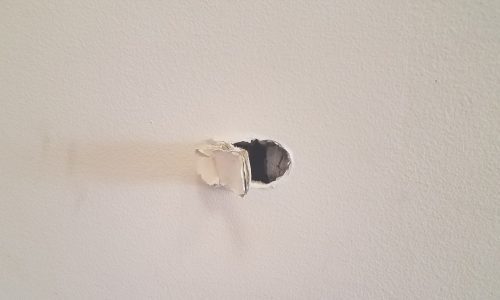 hole in wall in home interior from damage
