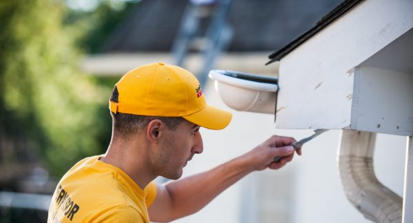 CertaPro Team Member working on a home exterior