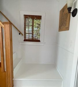 White staircase landing with natural wood railings.