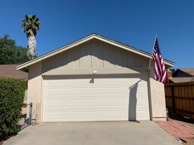 Garage after wood trim replacement and repainting.