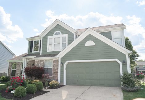 Green House with White Trim