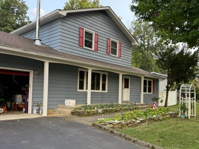 blue home with red accents and front porch