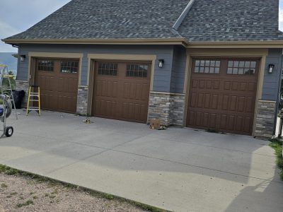 three car garage with brown painted doors