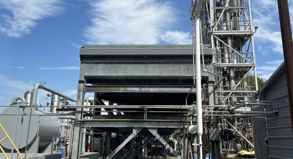 Wide view of the cooler structure, process piping, and steel process tower in Dayton, Ohio after industrial coating.