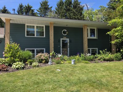 teal painted aluminum siding on house