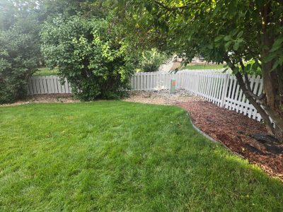 repainted white picket fence surrounding yard