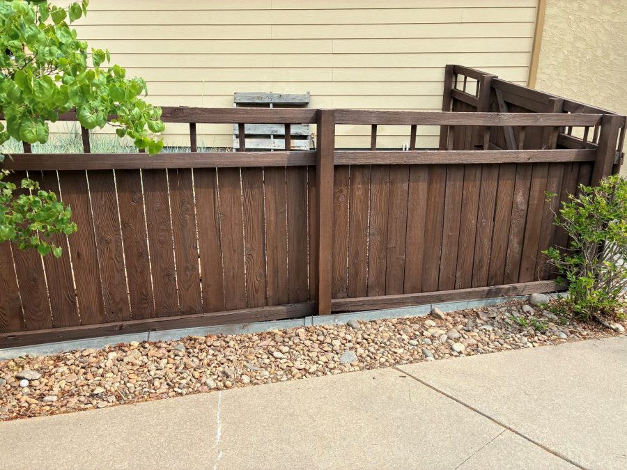 dark stained wooden fence surrounding house Preview Image 1