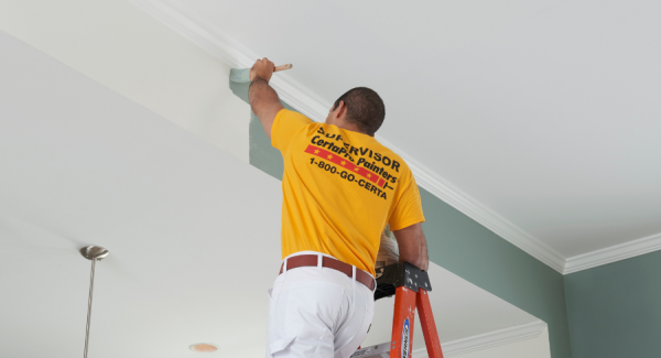 CertaPro Painter interior painting a ceiling from white to green