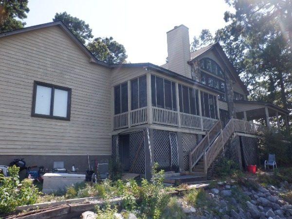 Rear of a Dadeville lake house before exterior painting with weathered siding and dark trim Preview Image 7