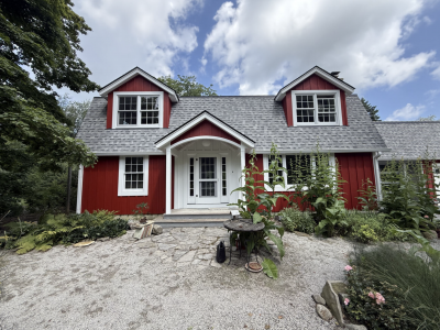 house with red stained wood siding and white trim