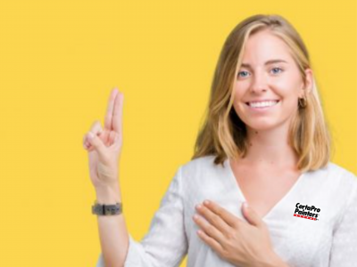 Blond woman holding up 2 fingers with gold background and CertaPro shirt on