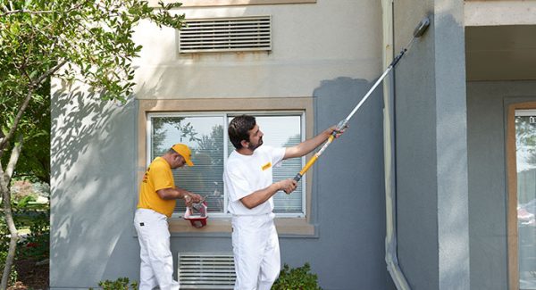 two certapro team members exterior painting stucoo home
