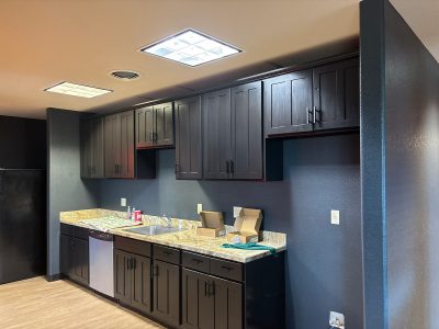 commercial space interior room with dark painted cabinets